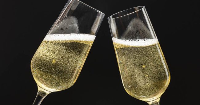 two festive champagne glasses celebration 1 Spumantizzazione - Enoteca Innusa